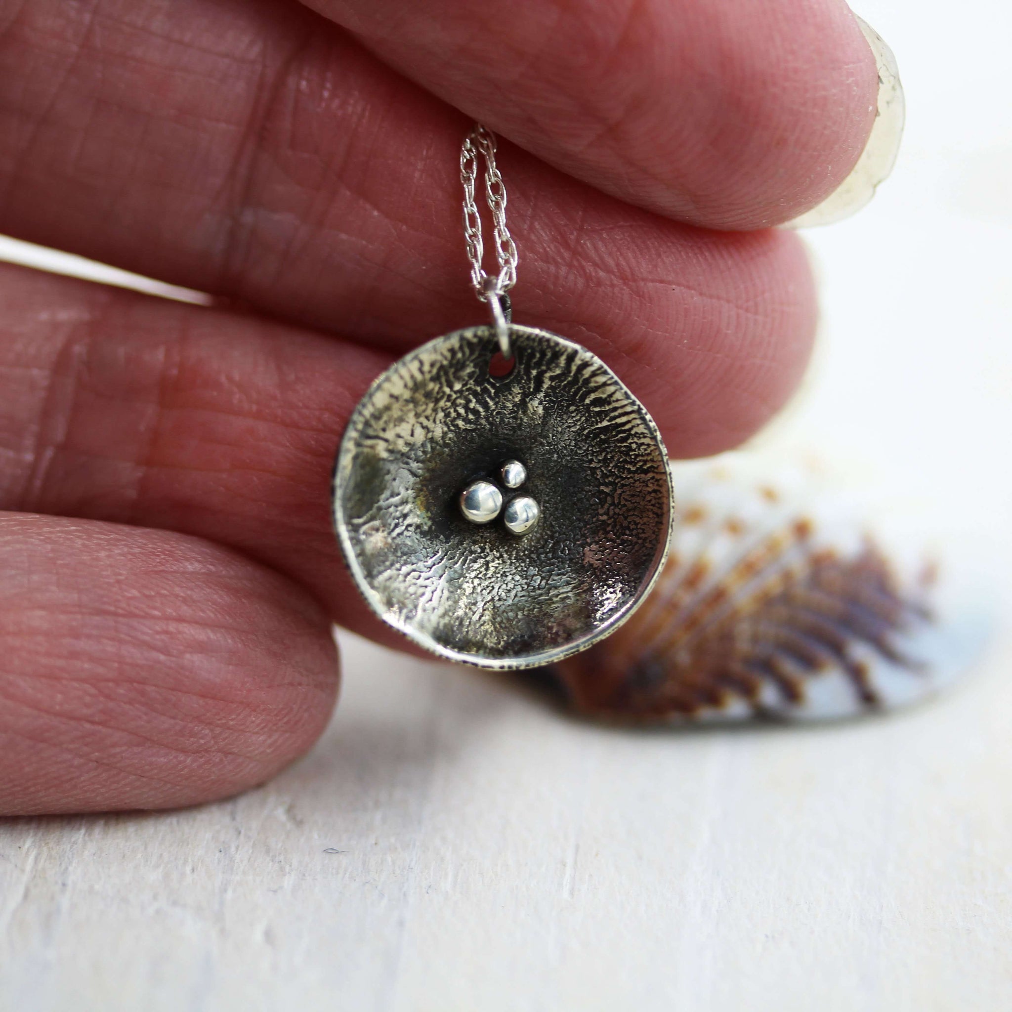 Handcrafted Pebbles on the Beach necklace, inspired by the pebbley shorelines of Suffolk and handmade in Sterling Silver 