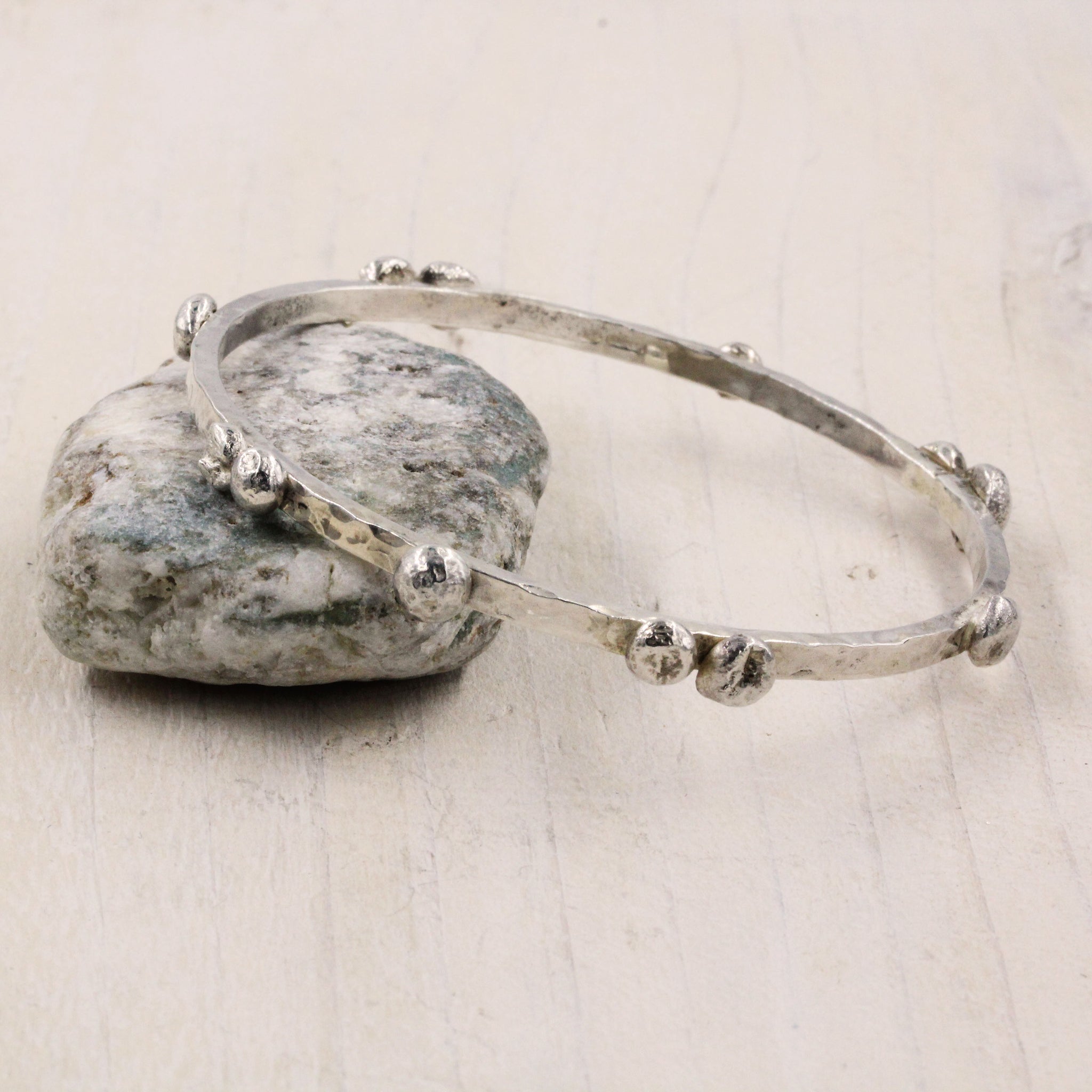 Handcrafted Pebbles on the Beach Bangle, inspired by the pebbley shorelines of Suffolk and handmade in Sterling Silver 